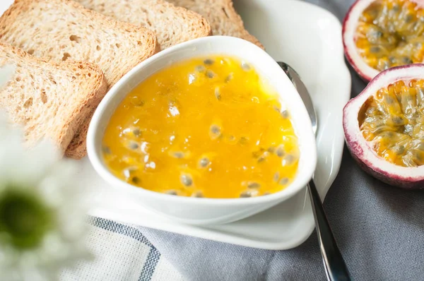 jam passion fruit flavor spread on homemade bread whole wheat, healthy breakfast.