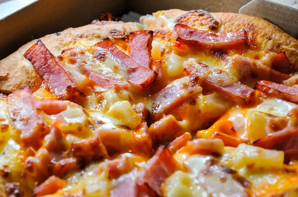 Mukavva içinde çeşitli malzemeler ve peynirli pizzaları kapatın. Açık kapaklı kutuları çıkarın.