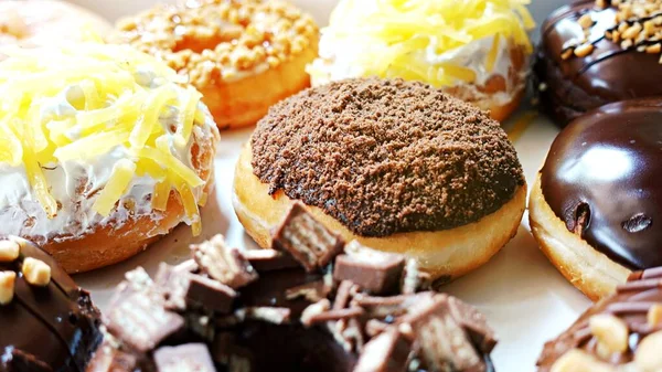 Close up Group of Glazed donuts on tray, tasty multiple assorted donut, Selective focusing on donut.