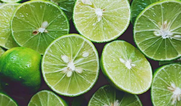 Lime Background. Close up shot of limes. Selective Focus of sliced lime. Lime is a kind of fruit. The result is very sour for cook the Thai food style