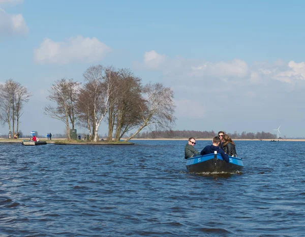 Young people in small boat — Stock Photo, Image