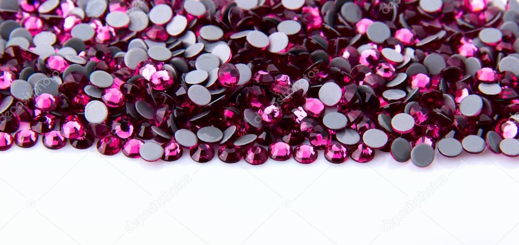 Precious sparkling rhinestones rose colors on a white background