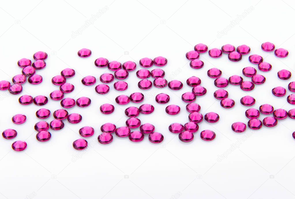 Precious sparkling rhinestones rose colors on a white background