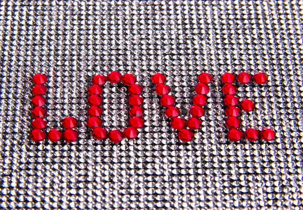 Kelime aşk arka plan bez rhinestones bir kristal üzerinde yapılan.