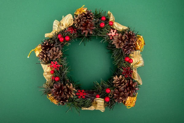 Corona de Navidad, Composición de vacaciones sobre un fondo verde. Vista superior . — Foto de Stock