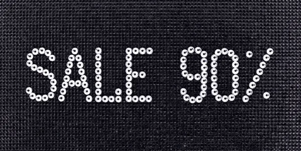 Word SALE is made rhinestones crystal color on a black canvas background. — Stock Photo, Image