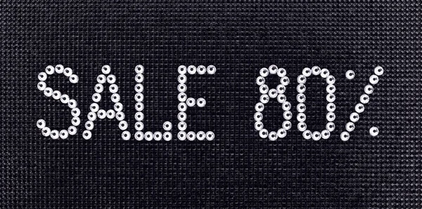 Word SALE is made rhinestones crystal color on a black canvas background. — Stock Photo, Image