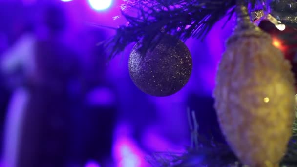 Karácsonyi disco az étteremben, a karácsonyfa, a háttérben egy diszkó tánc sziluettek emberek, könnyű sugarak, felismerhetetlen, Christmas tree játékok, 2018 — Stock videók