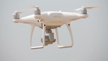 Beyaz quadrupter yüzer hava, quadrocopter sinekler, dönen Pervaneler, zemin hovering quadrocopter