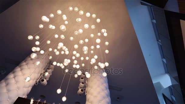 Hall of a hotel or restaurant, chandelier in the lobby, Chandelier hangs from the ceiling, creative, modern, interior, hotel or restaurant interior — Stock Video