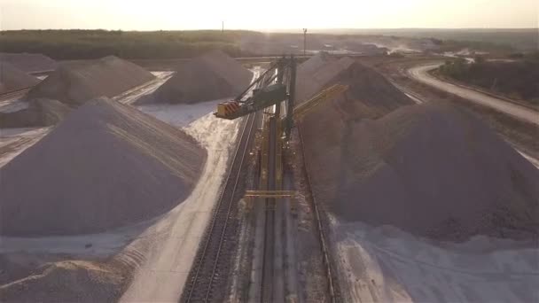 Aerial view, machinery working at clay quarry, heavy loaders, large trucks, bulldozers, excavators, Sand quarry, Mining, The train takes raw materials from the quarry, Large clay warehouse — Stock Video