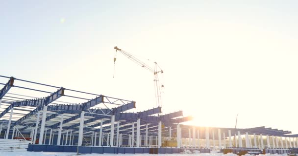 Moderne Lagerbaustelle, die Stahlkonstruktion eines neuen Geschäftshauses vor blauem Himmel im Hintergrund, der Bau einer modernen Fabrik oder Lagerhalle — Stockvideo