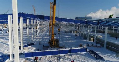 İnşaat sitede, Vinç vinç çalışmalarını demir kiriş yükseltir. İnşaat alanında yükseklikte emekçilerin inşaat sahasında işçiler. Tehlikeli bir iş.