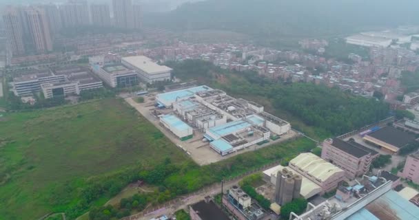 Overflight of small Chinese factories, mountains and residential area in the background — Stock Video