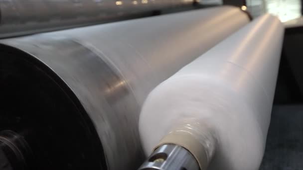 Rolls of non-woven fabric are being pushed into the tube. Nonwoven fabric production — Stock Video