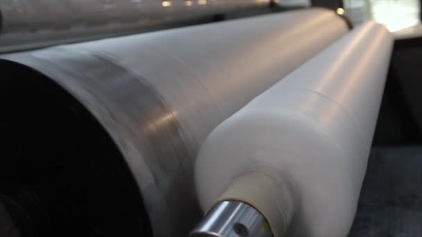 Pliester manufacturing process. Roll-up of non-woven fabric in a factory — Stock Video