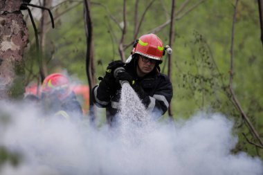 BÜKREŞ, ROMANIA - 17 Nisan 2017 'de Bükreş' te, ıssız bir eve yayılan bir yangını suyla söndürmeye çalışan itfaiyeciler