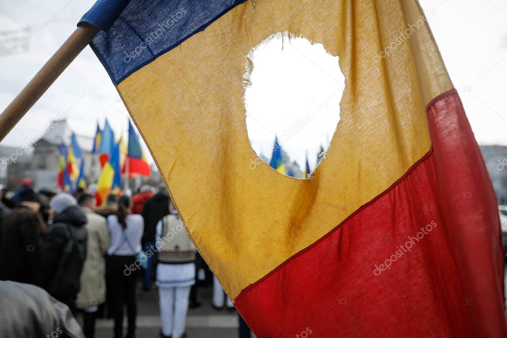 Details with the Romanian flag with a hole, the symbol of the Ro