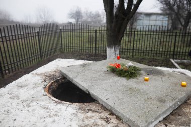 The manhole where the ashes of the burned bodies of victims from