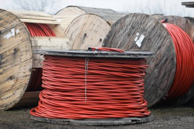 Wooden cable reels outdoors during a cold rainy day.