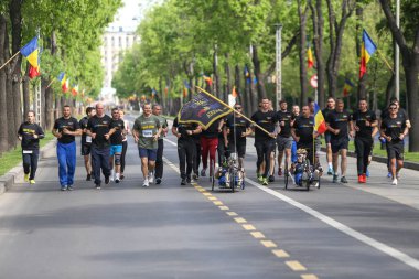 Bucharest, Romania - May 5, 2019: Romanian army veterans, paralympians members of the Invictus Team, take part at a running contest.