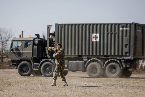 Otopeni, Romania - February 19, 2020: Personnel of the Romanian Army work on the installation of a campaign mobile hospital (ROL 2) to treat Covid-19 patients.