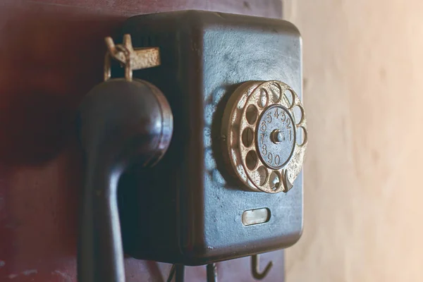 Retro rotary dial phone hanging on the wall