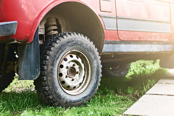 Red car with a suspension lift — Stock Photo, Image