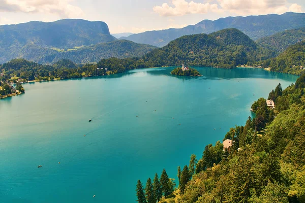 Wide angle view of Bled lake with mountains, island and pilgrimage church, view from the Bled Castle upper yard, Slovenia. Stock Picture