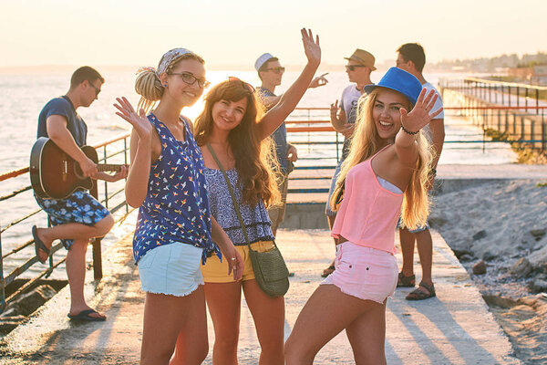 Friends hanging out at the sunny summer seaside