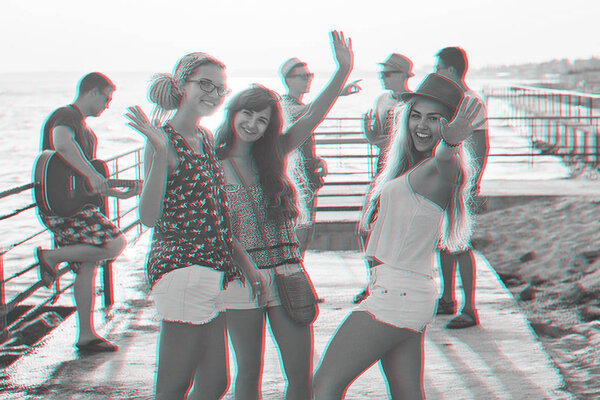 Friends hanging out at the sunny summer seaside