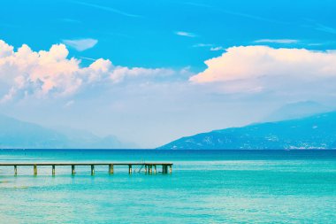 Turkuaz su ve şaşırtıcı pembe akşam bulutlar ile yaz lake Garda İtalya güzel manzaralı