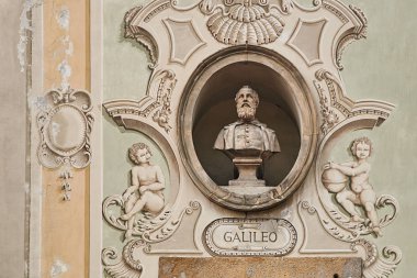Vintage sculpture portrait of Galileo Galilei on a facade of an old building in Bellinzona, Switzerland clipart