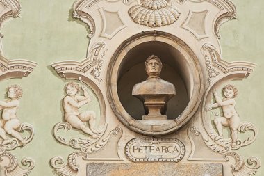 Vintage sculpture portrait of Francesco Petrarca on a facade of an old building in Bellinzona, Switzerland clipart