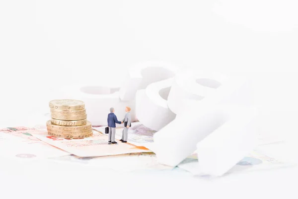 Miniature businesman shaking hands after completed a deal — Stock Photo, Image