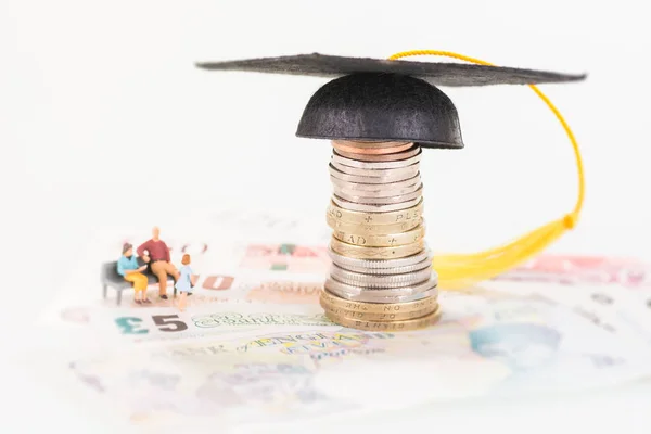 Miniature parents saving for their child's education fund — Stock Photo, Image