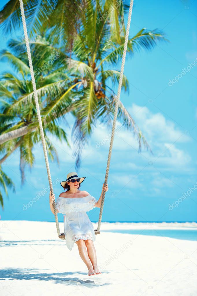 Beautiful woman swinging on a Tropical beach, Koh Phangan island. Thailand