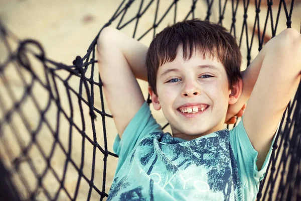 Lindo niño que se relaja en una hamaca —  Fotos de Stock