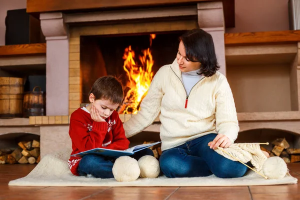 母と彼女の幼い息子自宅で暖炉のそばで — ストック写真