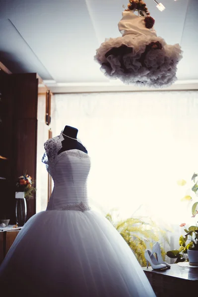 wedding dress on a hanger in room. Wedding morning.
