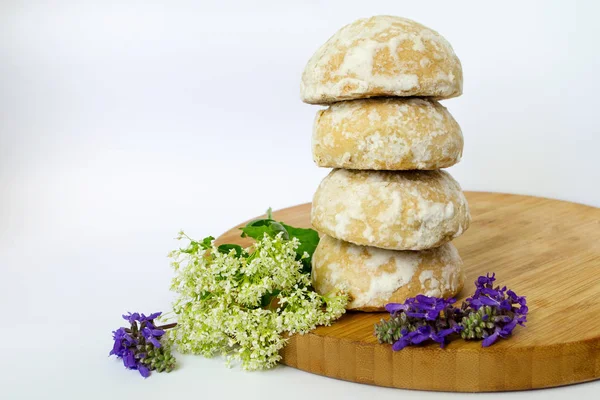 Natureza morta de biscoitos em uma tábua de madeira e flores de campanha — Fotografia de Stock