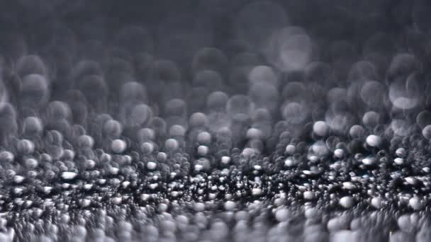 Salpicaduras de gotas de agua en una superficie brillante — Vídeos de Stock