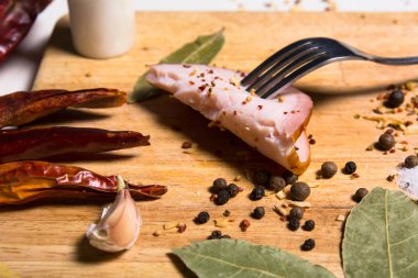 Bir dilim pastırma otlar gemide çatalla