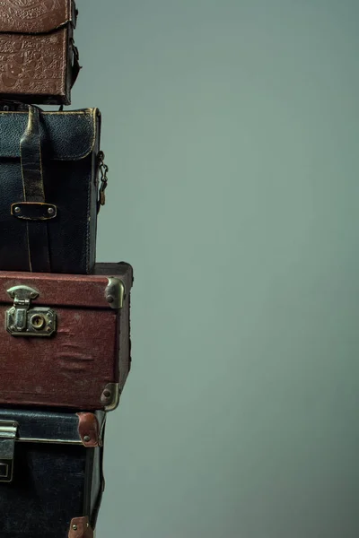 Background stack of old shabby suitcases form a tower