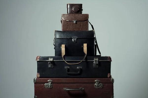 Background stack of old shabby suitcases and camera — Stock Photo, Image