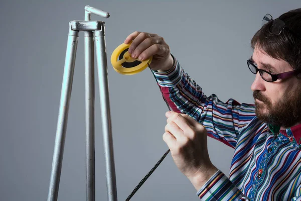 Bearded man looks at 8mm film — Stock Photo, Image