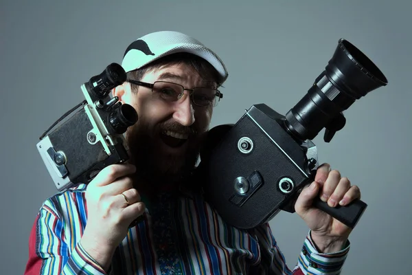 Smiling bearded man two old retro film camera — Stock Photo, Image