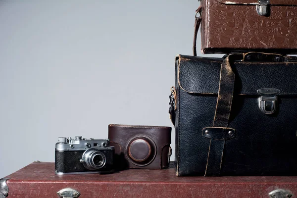 Camera and carrying case on old suitcase — Stock Photo, Image