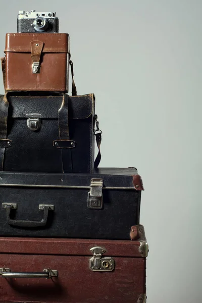 Stack of vintage shabby suitcases and camera — Stock Photo, Image