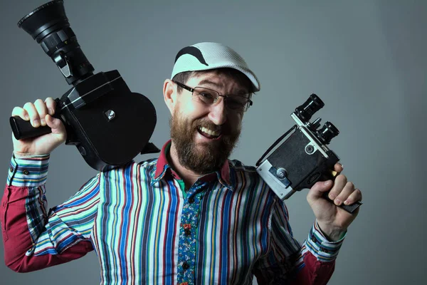 Laughing bearded man two old retro film camera — Stock Photo, Image